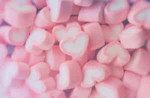 Pink,Marshmallow,In,Heart,Shape,Stacked,On,Blue,Wood,Table