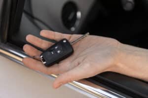 high-angle-hand-holding-car-key