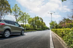 Car ride on road in sunny weather, motion blur