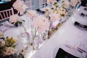 vases with peonies on table