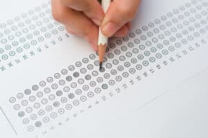 woman's hands filling in standardized test form