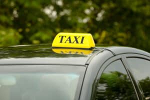 Taxi car on blurred background, close up view