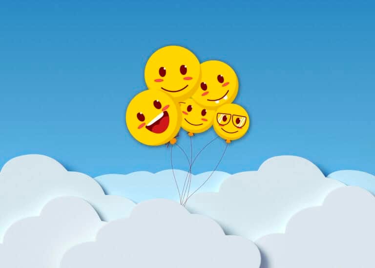 Vibrant green leafy smiley face made of fresh foliage on a white background.