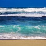 huge waves sea crashing sandy beach