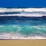 huge waves sea crashing sandy beach