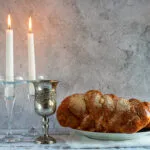 shabbat shalom challah bread shabbat wine candles wooden table